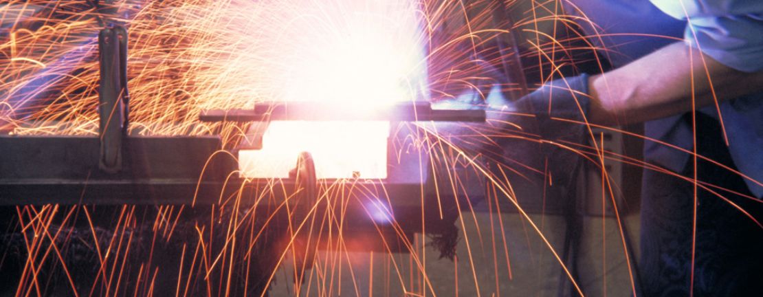 Close-up of man welding metal with sparks